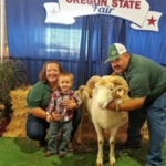 Becky and her family at fair with sheep.