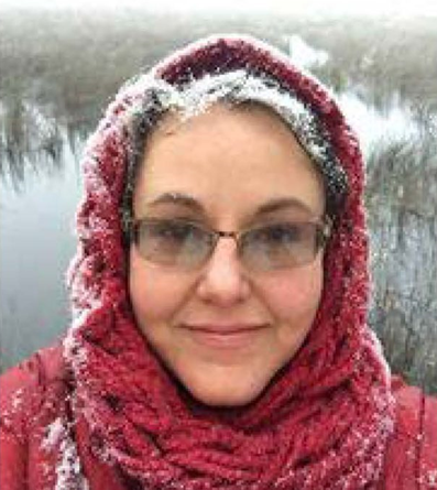 Sarah Hamilton in the snow with a red head scarf