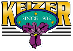 Gold font Keizer with a purple iris below a green oval that says Since 1982.