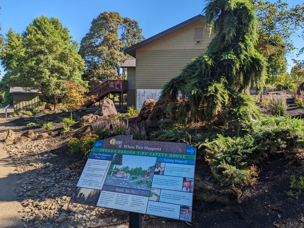 Fire Safety House with landscaping and an interpretive sign.