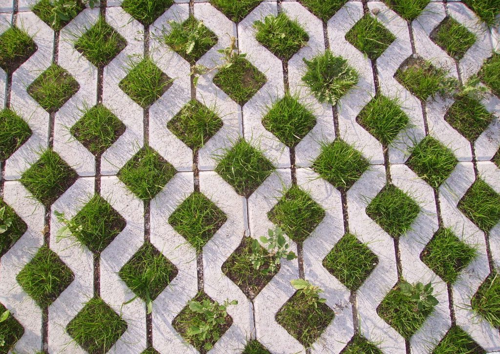 Pavers making a diamond shapes with green grass in the middle.