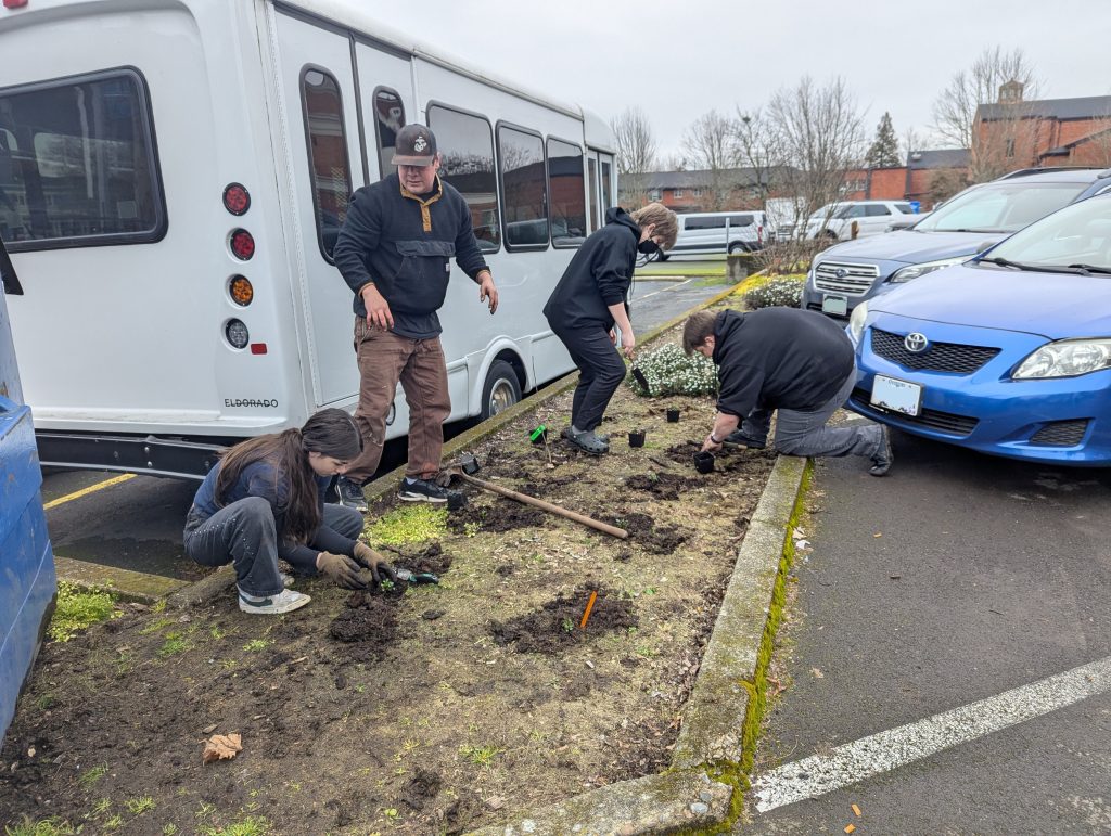 People working in a parking lot bed
